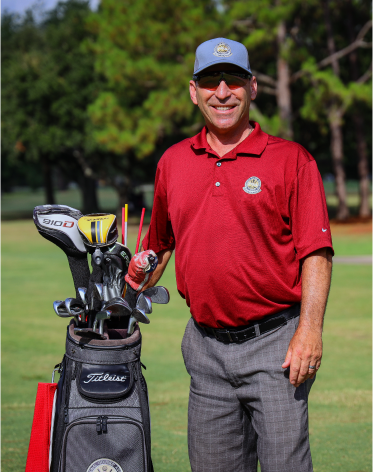 matt schewe standing with his clubs